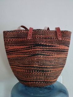 "Black and orange sisal tote bag DIMENSIONS Bottom width: 10\"/25.5cm Top width: 14\"/35.56cm Depth: 10\"/25.5cm Straps: 15\"/38cm SHIPPING All orders ship via DHL Express (3-5) days delivery time." Eco-friendly Black Bucket Bag With Leather Handles, Eco-friendly Black Shoulder Bag With Double Handle, Traditional Black Rectangular Crochet Bag, Handwoven Bucket Tote Bag For Daily Use, Eco-friendly Black Bags With Braided Handles, Black Basket Bucket Bag With Leather Handles, Eco-friendly Black Bucket Shoulder Bag, Eco-friendly Black Bags With Leather Handles, Eco-friendly Black Bucket Bag For Shopping