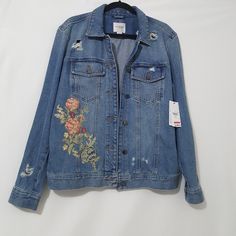 Medium Wash Distressed, Two Metal Button Flap Chest Pockets, Floral Embroidery, A Small Red Stain Inside Above Tag Label, A Small Fading Pinkish Stain Of Back, Adjustable Metal Buttons To Adjust The Bottom Fit, Women Size M Other Than Minor Stain Excellent Condition. Nwt Fall Outerwear With Multicolor Embroidery And Floral Print, Fall Floral Print Outerwear With Multicolor Embroidery, Fall Multicolor Embroidered Floral Outerwear, Fall Floral Print Multicolor Embroidered Outerwear, Blue Embroidered Relaxed Fit Outerwear, Blue Embroidered Outerwear With Relaxed Fit, Embroidered Relaxed Fit Outerwear For Fall, Floral Embroidered Cotton Button-up Outerwear, Winter Denim Jacket With Multicolor Embroidery