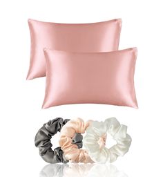 two satin scrunffle hair ties on top of each other next to a pillow