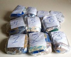 a pile of diapers sitting on top of a table covered in bags and numbers