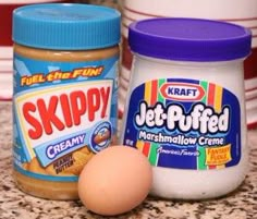 two jars of peanut butter and an egg sit on a counter top next to each other