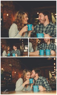 a man and woman sitting at a table with cups in their hands, laughing together