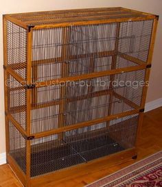 a large wooden bird cage with four sections