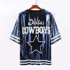 a t - shirt with the words dallas cowboys on it hanging from a hanger