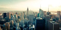 an aerial view of new york city with skyscrapers and other tall buildings in the foreground