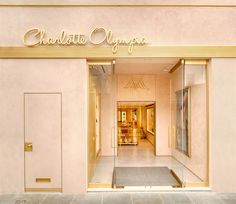 an entrance to a store with glass doors and gold lettering on the front door that says charlotte champs