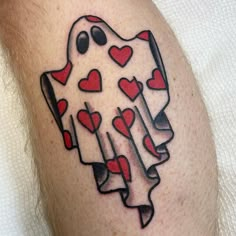 a man with a tattoo on his leg that has hearts in the shape of a ghost