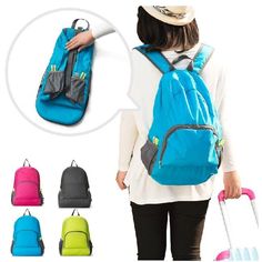 a woman with a blue backpack and pink suitcase in front of her back to the camera