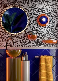 a bathroom with blue walls and orange accessories on the shelf next to the toilet is decorated in an unusual pattern