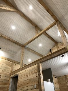 the inside of a building with wooden walls and ceilings