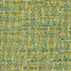 a green and yellow fabric with small squares on the top, as well as some smaller dots