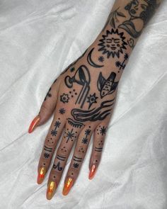 a woman's hand with tattoos on it