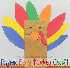 a paper bag shaped like a turkey with colorful feathers on it's head and tail