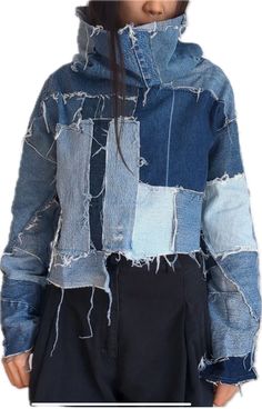 a woman wearing a jean jacket with holes on it