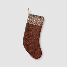 a knitted christmas stocking hanging on a wall