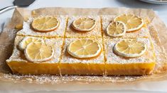 there is a cake with lemons on it and powdered sugar around the edges