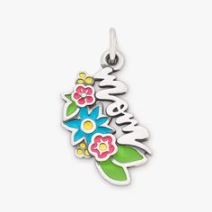 a flowered charm with the word mom on it's back and flowers in the middle