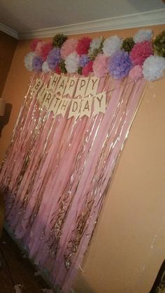 a birthday decoration with pink and purple flowers