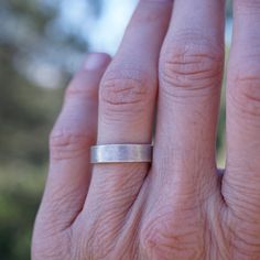 This ring has a light texture for those who don't care for shiny silver. It has a lovely soft glow instead. This would make a great wedding band. Made of sterling silver. Measurements: The band is 3/16" wide. Fits size 5.5. The band is about 1mm thick. Ring comes in a hand-sewn drawstring gift bag made out of repurposed fabrics or an eco-friendly gift box. Silver Thick Band For Everyday, Silver Thick Band For Everyday Wear, Minimalist Wide Band Stackable Rings For Anniversary, Silver Stackable Rings With Thick Band For Anniversary, Silver Minimalist Wide Band Ring For Wedding, Minimalist Silver Wide Band Ring For Wedding, Minimalist Silver Bands For Promise Ring, Minimalist Thick Band Ring Stamped 925, Silver Minimalist Wide Band Ring For Anniversary