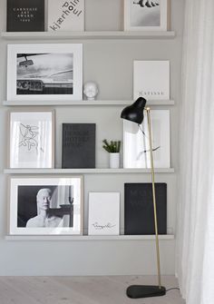 the shelves are filled with pictures, books, and other decorative items in black and white