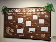 a bulletin board with paper cutouts on it that says anything is fossil - abig