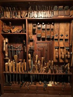 an old wooden cabinet filled with lots of woodworking tools