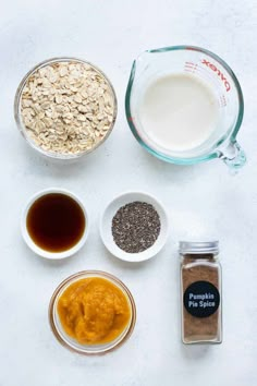 ingredients to make oatmeal in small bowls on a white surface