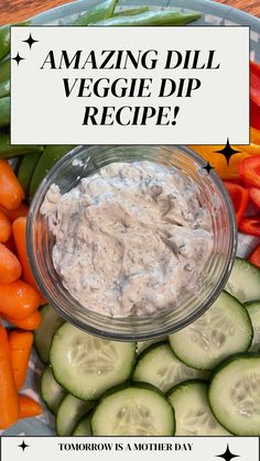 a bowl of dip surrounded by cucumbers and carrots