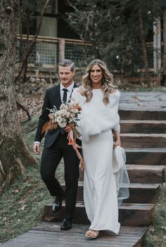 a bride and groom are walking down the stairs