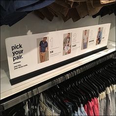 a rack with shirts and pants on it in a clothing store or department store that sells men's t - shirts