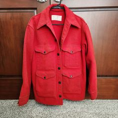 A vintage Filson 10% wool red cruiser or mackinaw style coat. The only label is the one shown and there is no size tag.  Measurements taken flat as follows: Armpit to armpit - 23.5" Shoulder width - 19.5" Sleeve length - 23.5" Length from base of neck in back - 28" Condition: This coat is generally soiled.  It is dryclean only and has not been cleaned. There are also numerous obvious stains on the front, sleeves, back and on the inside. There is a small hole in one cuff as seen in the last photo.  The photos make it look cleaner than it is, so assume up close it will appear more soiled than it looks here. Otherwise structurally it is in good shape. Vintage Pea Coat With Pockets For Workwear, Vintage Style Pea Coat With Pockets For Work, Wool Collared Pea Coat With Pockets, Retro Wool Outerwear With Lapel Collar, Collared Wool Outerwear With Snap Buttons, Vintage Winter Pea Coat With Pockets, Vintage Long Sleeve Pea Coat With Pockets, Retro Long Coat Outerwear With Pockets, Red Wool Long Pea Coat