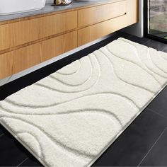 a bathroom with a large white rug on the floor