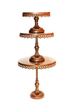 three tiered cake stand with two plates on each side and an intricately decorated top