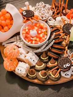 a platter filled with cookies, candy and candies as well as halloween treats