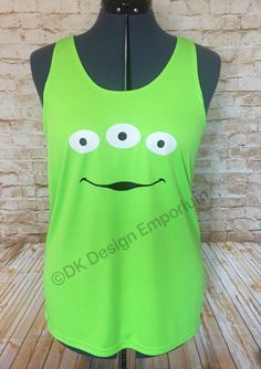 a green tank top with an angry face drawn on the front and eyes painted on the back