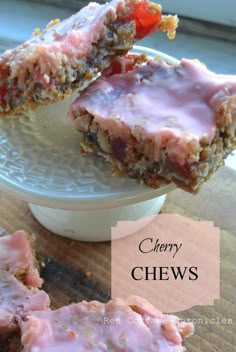 chewy chews are sitting on a plate next to a bowl full of fruit