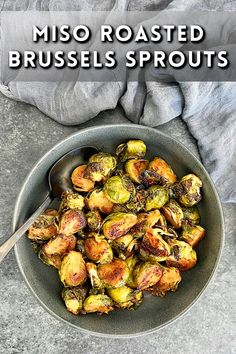 a bowl filled with roasted brussel sprouts on top of a table