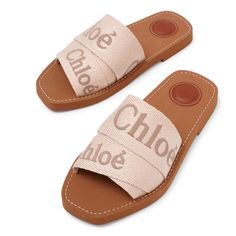 Beige linen slides from Chloé. The Woody slides are made of different-sized ribbons with a contrasting Chloé logo across the top, along with the designer's "O" signature on the inner sole. It is complete with ecru stitches on the rubber sole.Rubber soleTrue to sizeMade in Italy Chloe Slides, Sandals Aesthetic, Shuffle Cutouts, Luxury Wishlist, Chloe Logo, Chloe Sandals, Designer Sandals, Summer 2024, Slide Sandals