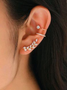 Elevate your everyday style with this exquisite ear stack set, featuring 14K gold-filled rhinestone cubic zirconia stud earrings paired with two matching gold ear cuffs. Designed for the modern muse who craves elegance with a hint of edge, these shimmering studs and sleek cuffs promise to turn heads wherever you go. Each piece is crafted with a luxurious 14K gold-filled finish and set with sparkling cubic zirconia stones that dance in the light, creating an irresistible allure. Perfect for those who love to mix and match, this set allows you to create endless looks--from chic minimalism to bold statement vibes. Treat yourself or surprise someone special with a gift that speaks volumes about their unique style!  Unlock your inner style icon and let your ears do the talking! 14k Gold Ear Cuff, Unusual Gifts For Women, Flower Ear Cuffs, Leaf Ear Cuffs, Ear Cuff Jewelry, Ear Climbers Earrings, Gold Ear Cuff, Climber Earrings, Ear Cuff Earings