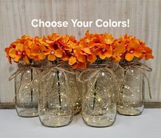 four mason jars with orange flowers in them and the words choose your colors above them