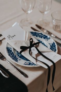 a place setting with blue and white plates