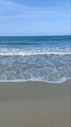 the ocean waves are rolling in to shore