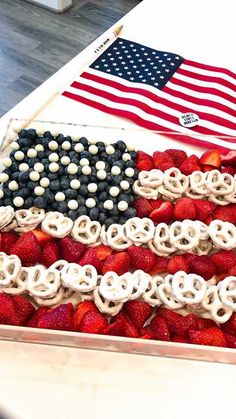 an american flag made out of pretzels and strawberries in a wooden box