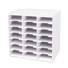 a large white storage unit with compartments on the front and bottom shelves in different sizes