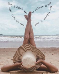 a woman laying on top of a sandy beach under a blue sky with words above her