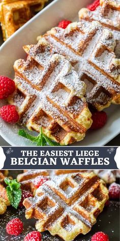 waffles with powdered sugar on top and raspberries in the background