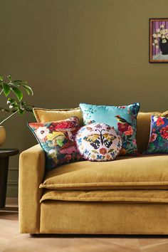 a yellow couch with colorful pillows on it