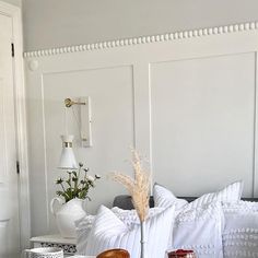 a bed with white pillows and decorative items on it