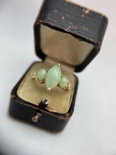 Display ring box is not included in purchase Stone: Nephrite Jade Metal: 14k yellow gold Weight: 3 grams dimensions: height 28 mm, width 23 mm, depth 15 mm Note:  stamped 14K Size 11 Can be sized by a reputable jeweler. We are new to Etsy, but our home store in Evansville, IN has been in business since 1898. We are a 5th generation family-owned business and have certificates in diamond grading from the GIA (Gemological Institute of America). All items listed in our shop are vintage or antique so imperfections can be expected but we always disclose them in the notes above. Accepted payment methods -PayPal, Visa, Mastercard, Discover, AmEx -Etsy gift card Cancelations  -Must be made within 48 hours, before your purchase is shipped.  Returns and Exchanges -We guarantee that your purchase will Classic 14k Gold Marquise Birthstone Ring, Marquise Cut Multi-stone Yellow Gold Diamond Ring, Heirloom Three Stone Marquise Ring, Fine Jewelry Marquise Three-stone Ring, Fine Jewelry Marquise Three-stone Piece, Fine Jewelry With Marquise Three-stone Design, Fine Jewelry Marquise Three-stone, Gold Marquise Emerald Ring In 14k Gold, Fine Jewelry Marquise Three Stone