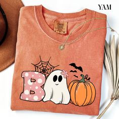 Boo Comfort Colors® T-shirt , Halloween Boo Shirt, Halloween Pumpkin Outfit, Spooky Season Tee, Ghost Clothing, Halloween Party Women Gifts ORDERING INSTRUCTIONS: -Carefully review all available photos. -Choose your desired T-shirt size from the dropdown menu. -Select your preferred T-shirt color from the available options. -Indicate the desired quantity. -Add the selected items to your cart. -Proceed to complete the checkout process. PRODUCT DETAILS: Brand: Comfort Colors Material: 100% cotton Spooky Orange T-shirt For Fall, Orange Halloween T-shirt With Letter Print, Halloween Funny Print Orange T-shirt, Orange Funny Print T-shirt For Halloween, Orange Halloween T-shirt With Funny Print, Spooky Orange Tops With Funny Print, Spooky Orange Crew Neck T-shirt, Spooky Long-sleeve Orange T-shirt, Spooky Long Sleeve Orange T-shirt